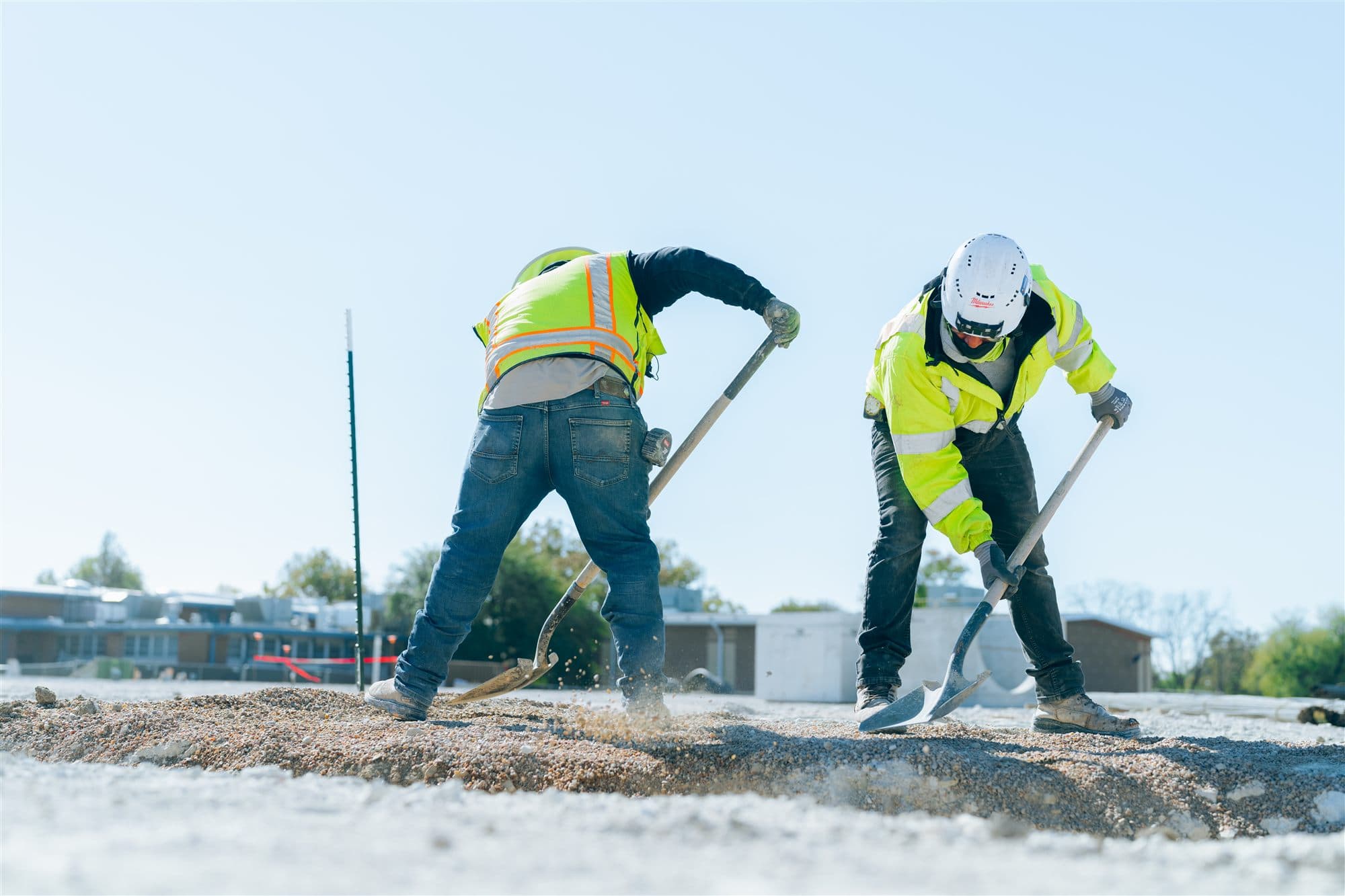 MJ Mechanical crew backfilling a utility trench at a Texas school campus