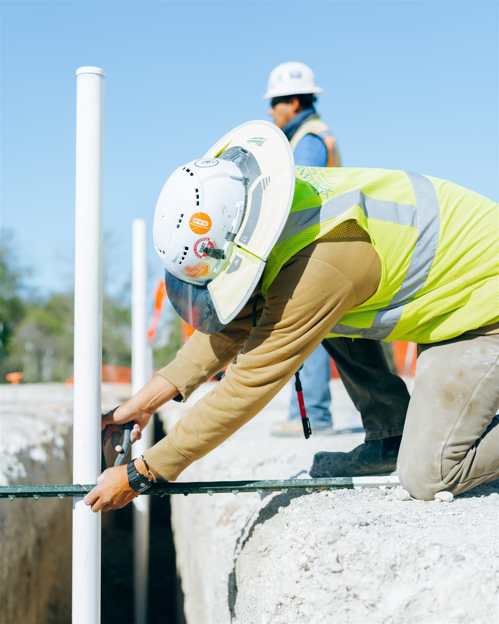 MJ Mechanical crew installing pipe at a trench stub-up on the Burnet Middle School jobsite