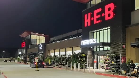 H-E-B Allen storefront entrance at night
